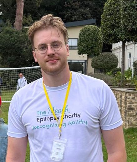 Max Attwood wearing a Meath T Shirt outside the main building at The Meath Epilepsy Charity