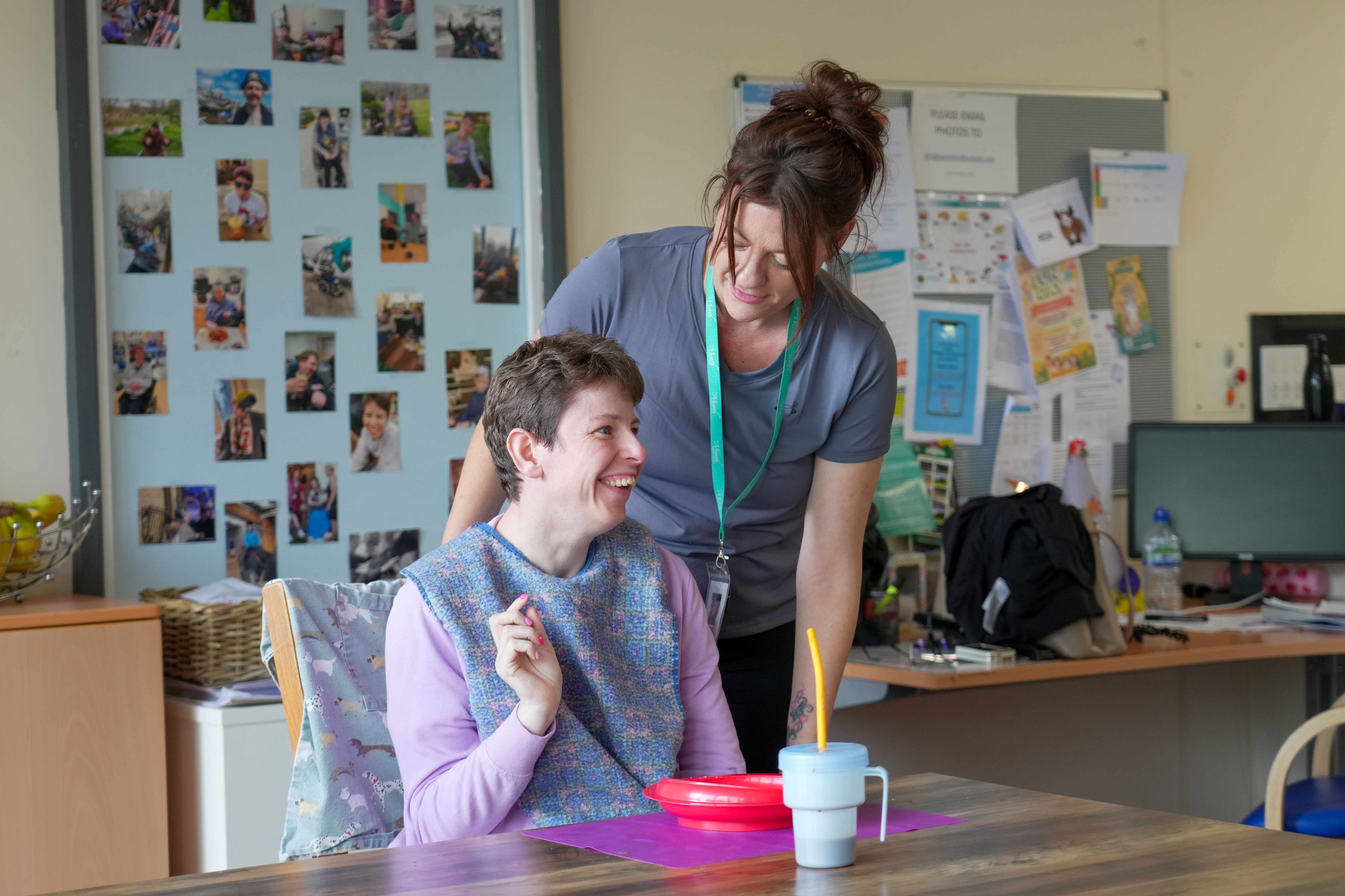 A resident being supported to enjoy lunch at home at Bradbury House.