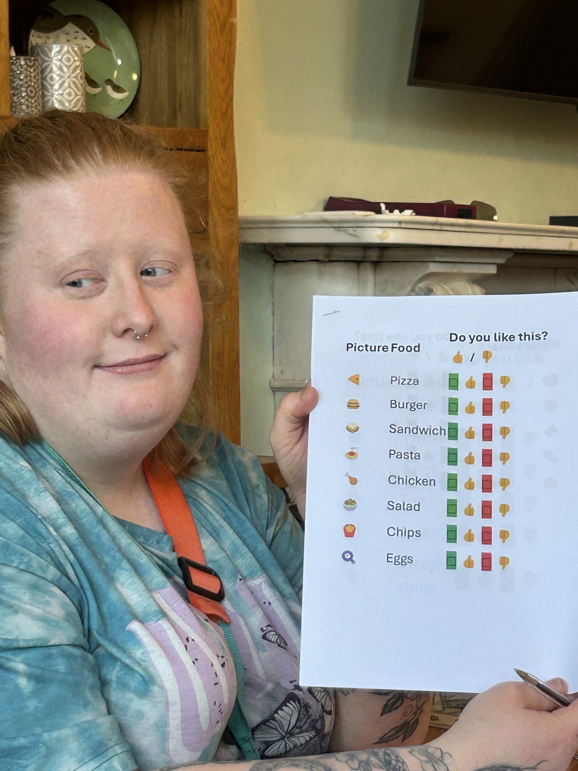 A woman with red hair smiles and holds up a sheet of menu suggestions.