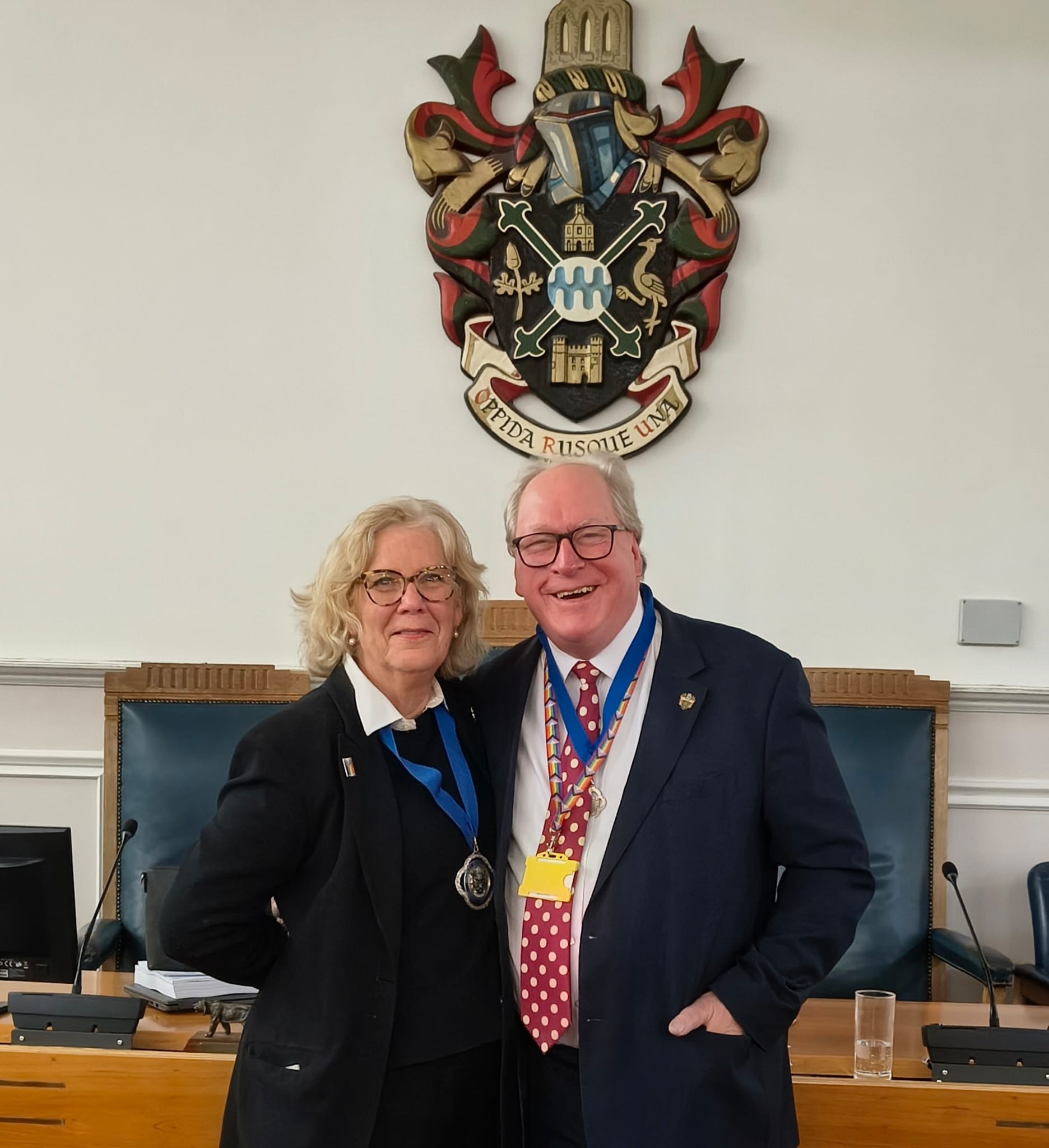 Cllr Penny Rivers, outgoing Mayor of Waverley with Mayor Consort Cllr. Paul Rivers stood smiling in council chambers.